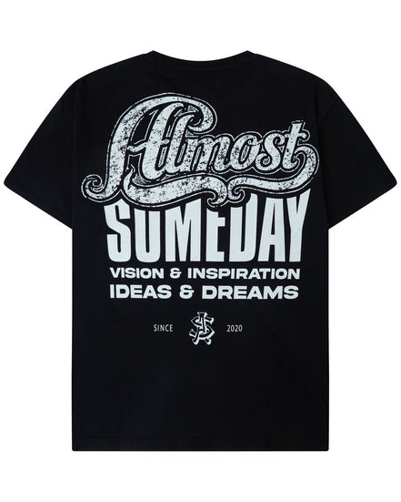 A black short-sleeve t-shirt shown from the back, featuring a large white graphic print that reads 'Almost Someday' with 'VISION & INSPIRATION IDEAS & DREAMS' underneath.