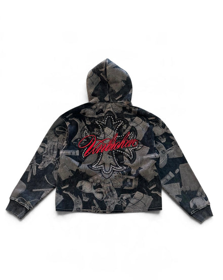 A cropped zip-up hoodie with a dark gray and black abstract collage print, featuring a large red 'Unbroken' script logo with rhinestone detailing on the back, shown against a plain white background.