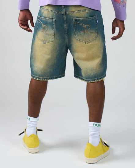 Person wearing blue denim shorts, yellow sneakers, and white socks with text on a white background