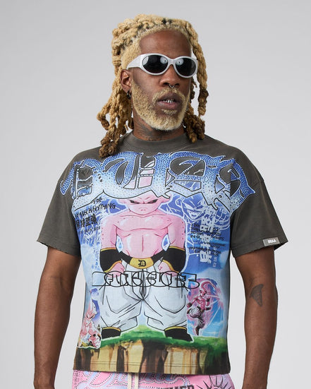 A man with blonde dreadlocks and sunglasses wearing a dark gray graphic t-shirt featuring a colorful Dragon Ball Z print of Majin Buu, set against a plain light gray background.