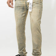 Person wearing distressed beige jeans with a visible brand label on a white background