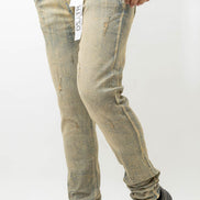 Person wearing light-colored distressed jeans and black shoes on a white background