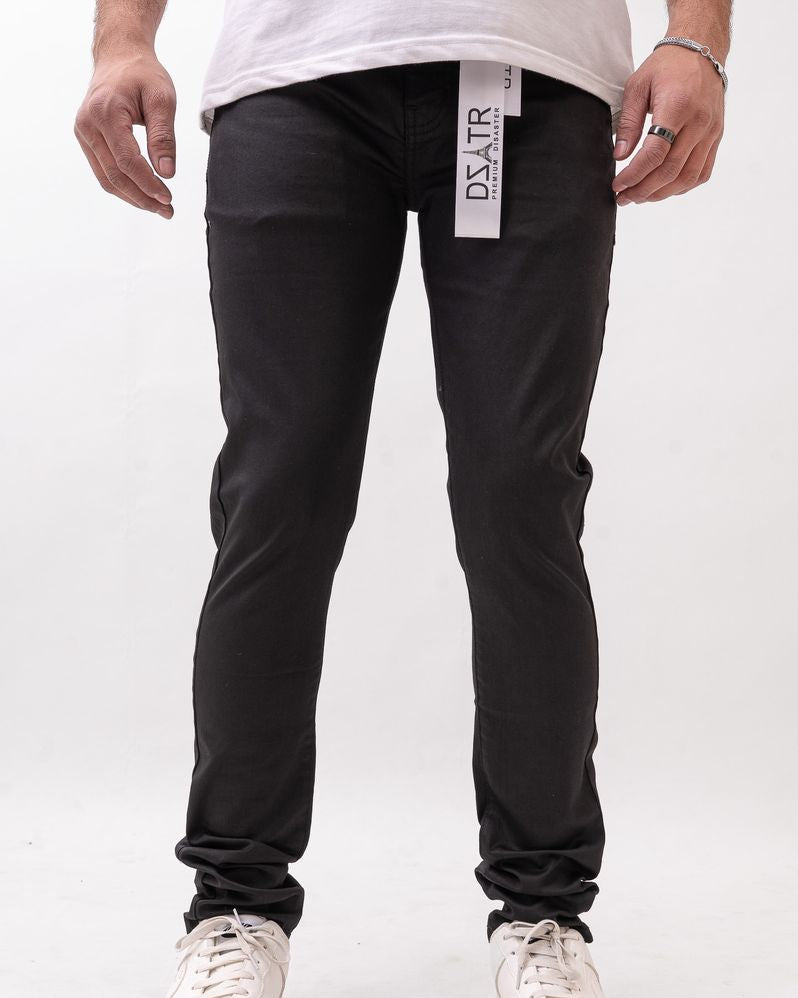 Person wearing black pants with a visible brand label on a white background