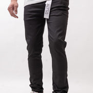 Person wearing black pants with a visible brand label on a white background
