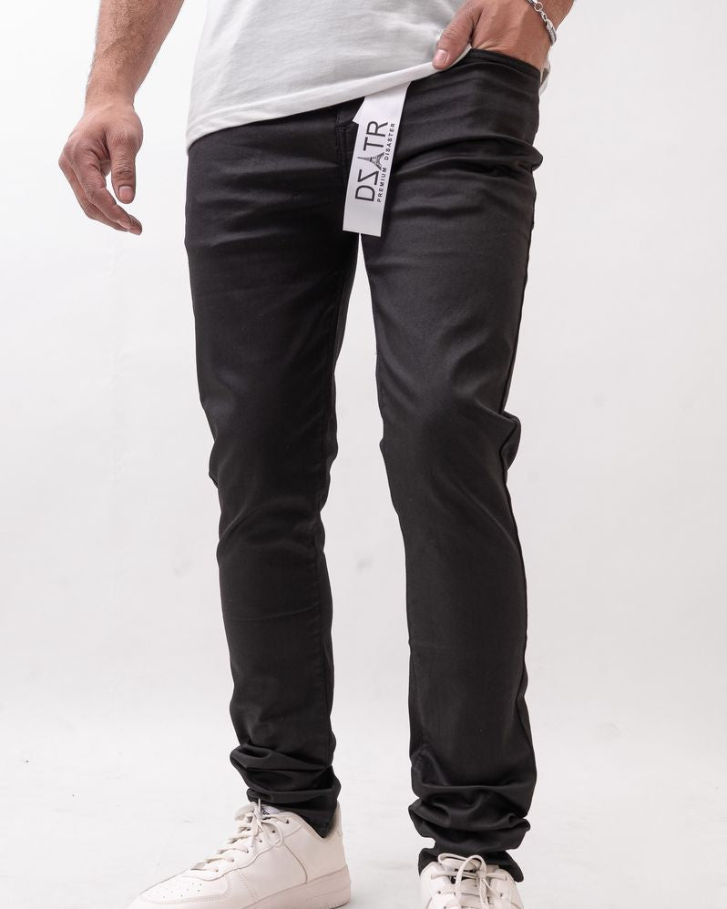 Person wearing black pants with a visible brand label on a white background