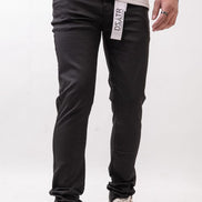 Person wearing black pants with a visible brand label on a white background