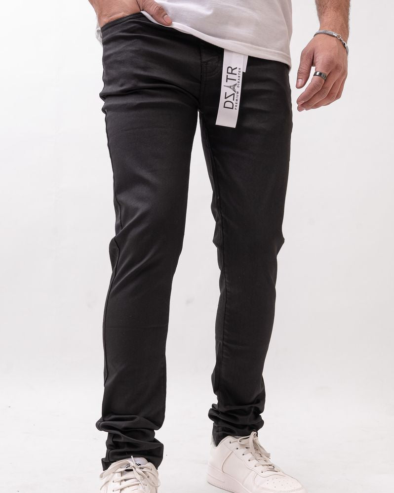 Person wearing black pants with a visible brand label on a white background