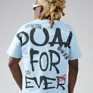 Person wearing a light blue t-shirt with black text on the back, standing against a plain background.