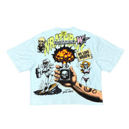 A light blue short-sleeve t-shirt with a large, detailed back graphic featuring cartoon skeletons, a hand holding a skull-topped device, and text including 'WRATH' and 'WE LOVE WRATH'.