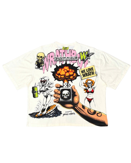 A white short-sleeve graphic t-shirt featuring a detailed illustration from the movie 'Wrestle Man 2'. The graphic includes the text 'WRESTLE MAN 2' in pink and green, a skeleton drinking from a green can, a pin-up girl holding a sign that says 'WE LOVE WRESTLE', and a hand holding a small TV with a skull on the screen.