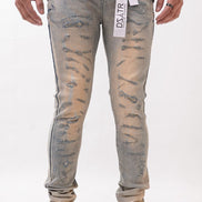 Person wearing distressed light blue jeans with a brand label on a white background