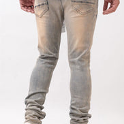 Person wearing light gray jeans and white sneakers on a white background