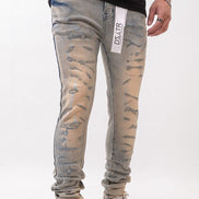 Person wearing distressed gray jeans with a visible brand label on a white background