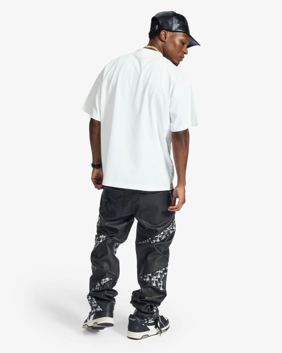Person wearing a white t-shirt, black cap, and black pants with white patterns on a white background