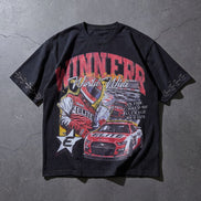 Black t-shirt with racing-themed graphic on a gray surface