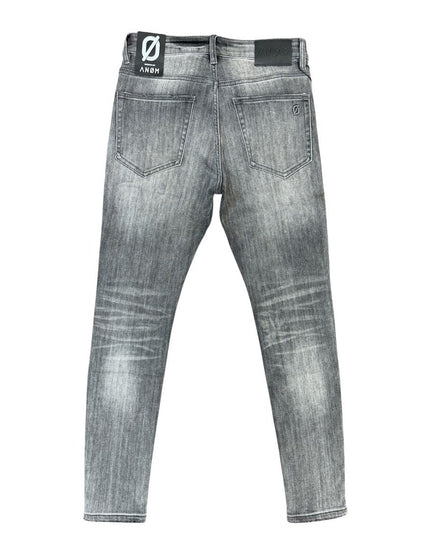 Gray washed denim jeans shown from the back, featuring a faded gray wash, classic five-pocket design, and a black brand patch on the back waistband.