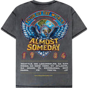 A dark gray washed graphic t-shirt shown from the back, featuring a large colorful print of an eagle and globe with the text 'TOUR OF THE WORLD ALMOST SOMEDAY 1984' and a list of tour cities.