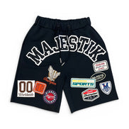 Black shorts with various patches on a white background