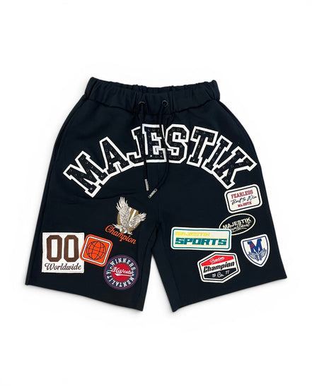 Black shorts with various patches on a white background