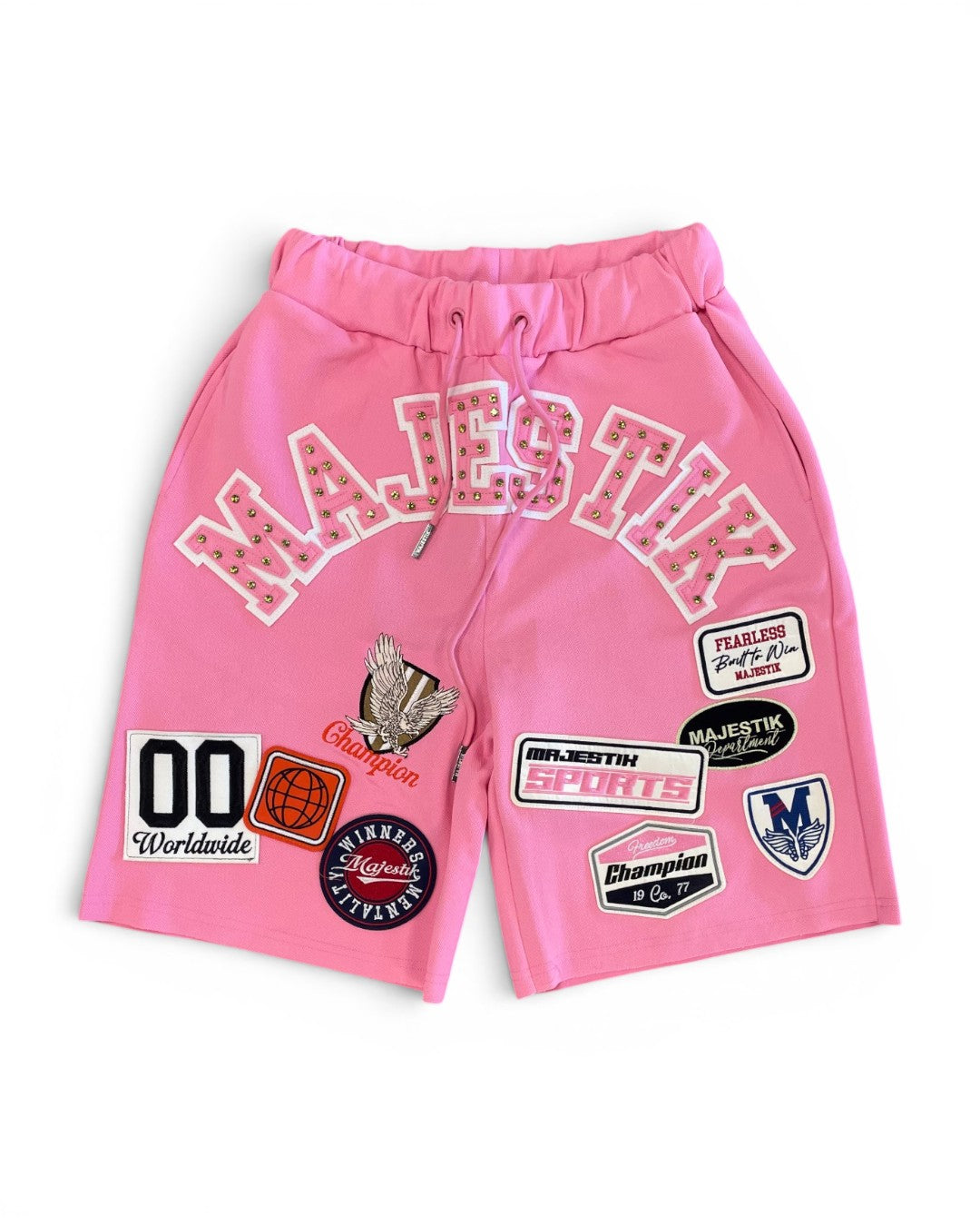Pink shorts with various patches on a white background