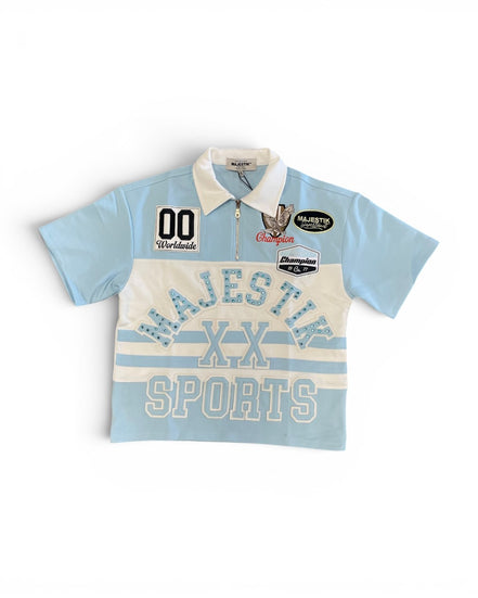 Light blue and white polo shirt with 'Majestik Sports' branding on a white background