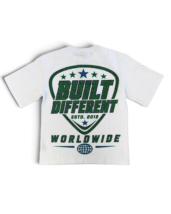 A white short-sleeve t-shirt with a green graphic print on the back. The graphic features a shield design with the words 'BUILT DIFFERENT', 'ESTD.
