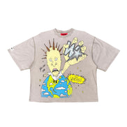 A light beige oversized short-sleeve t-shirt featuring a colorful graphic print of a cartoon character with a star for a head, holding a globe, with a yellow 'W' speech bubble.