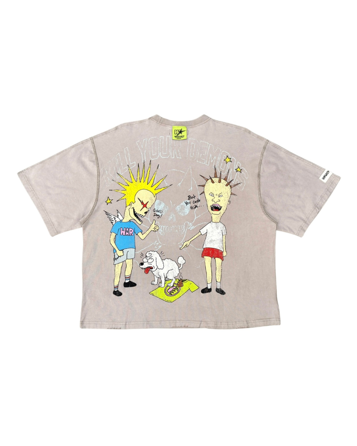 A light beige graphic t-shirt featuring a cartoon illustration of two characters and a small white dog, displayed flat against a white background.