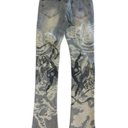 Blue jeans with black and white floral patterns on a white background