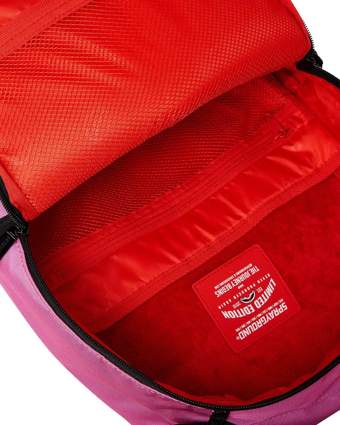 Close-up of a red interior of a bag with a visible brand label.