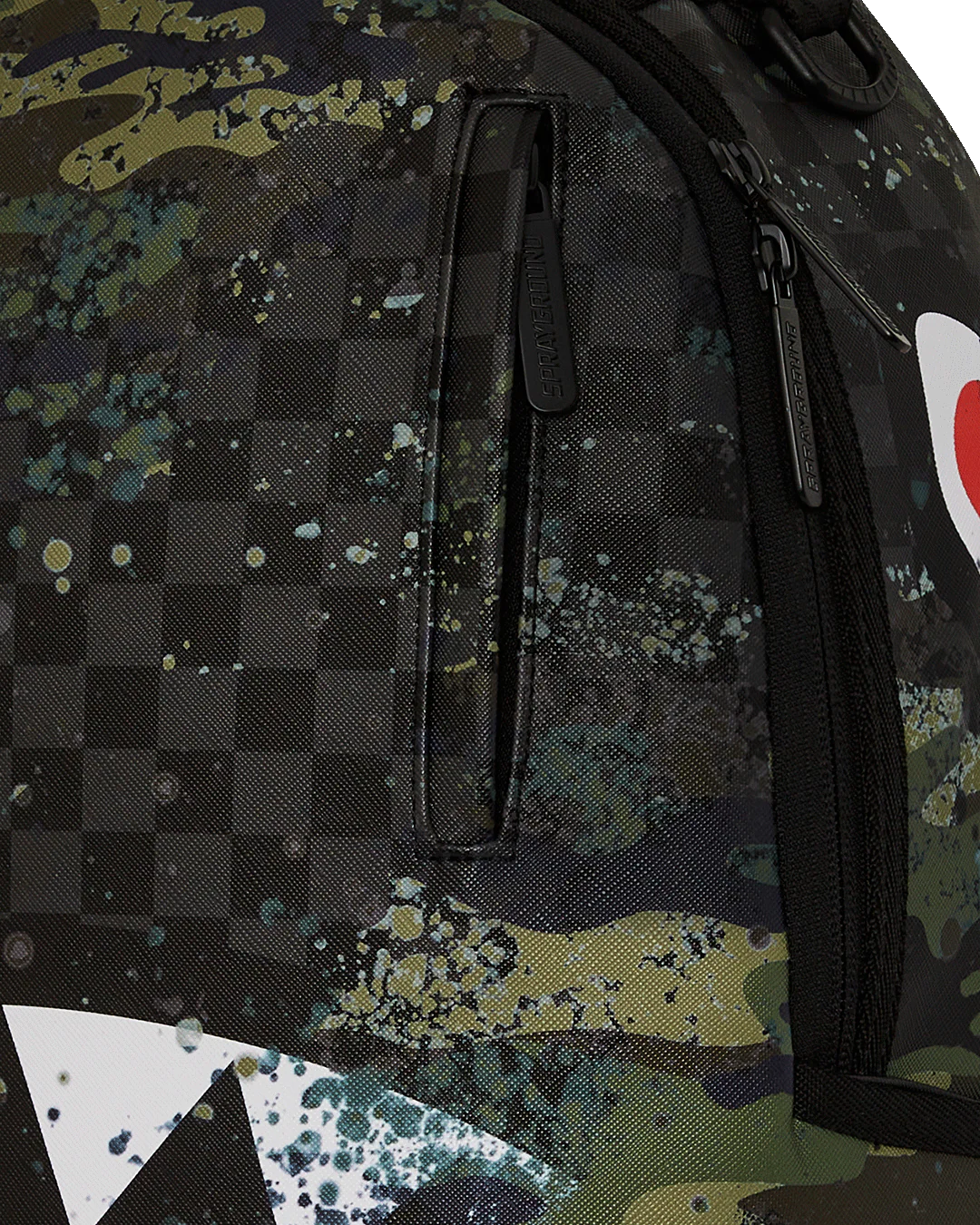 Camouflage backpack with a checkered pattern and splash designs on a white background
