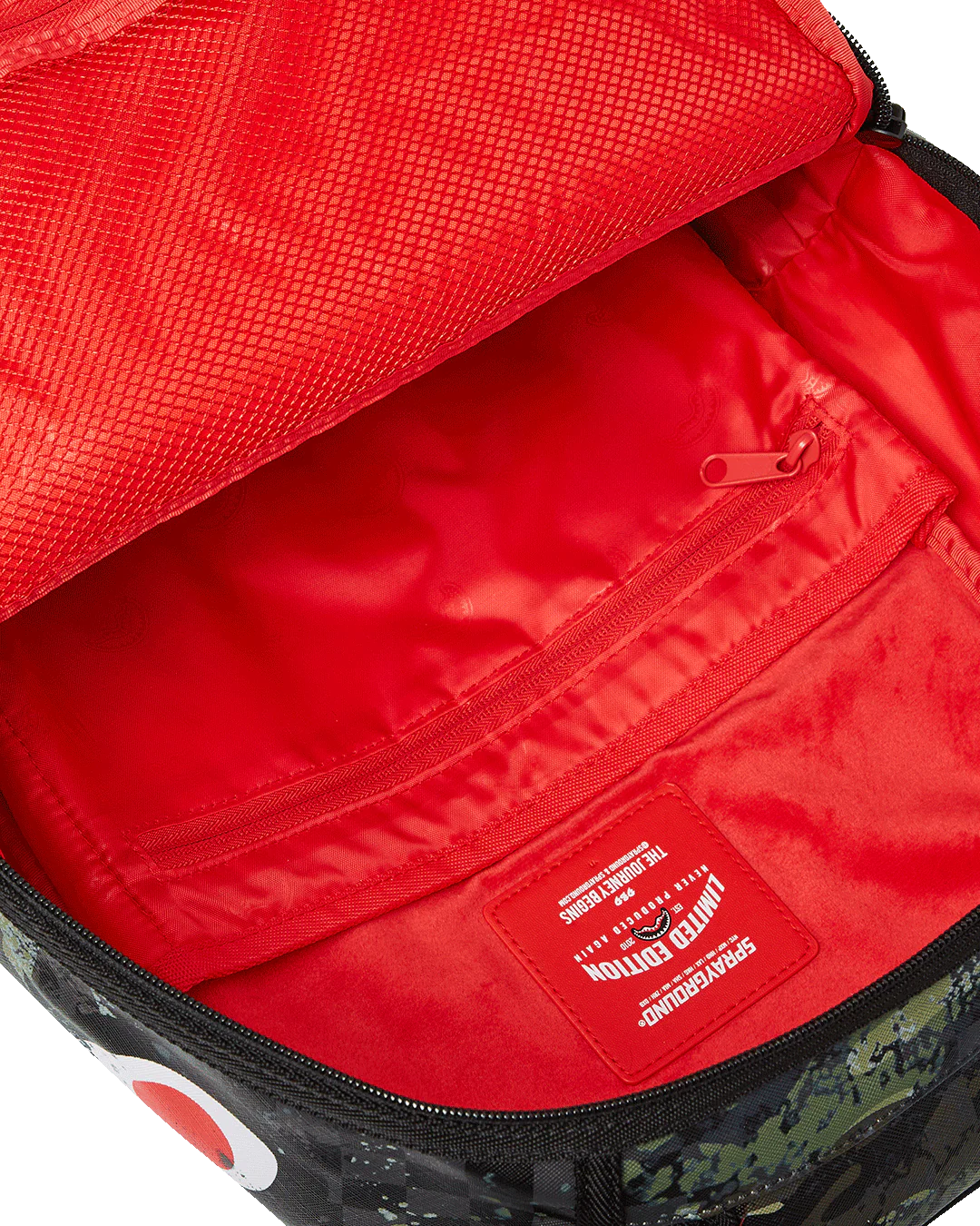 Red interior of a bag with a visible brand logo.