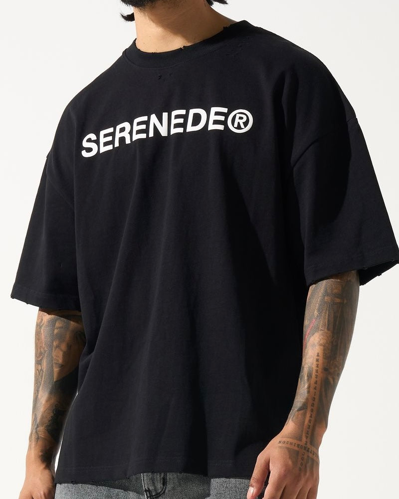 A male model wearing a black crew neck t-shirt with the brand name 'SERENEDE' printed in white on the chest.