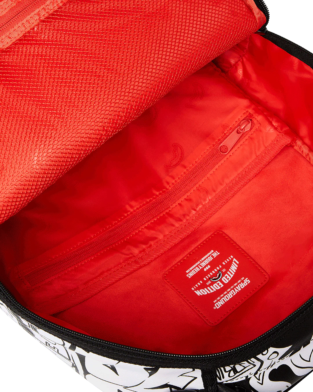 Red interior of a bag with a visible brand logo