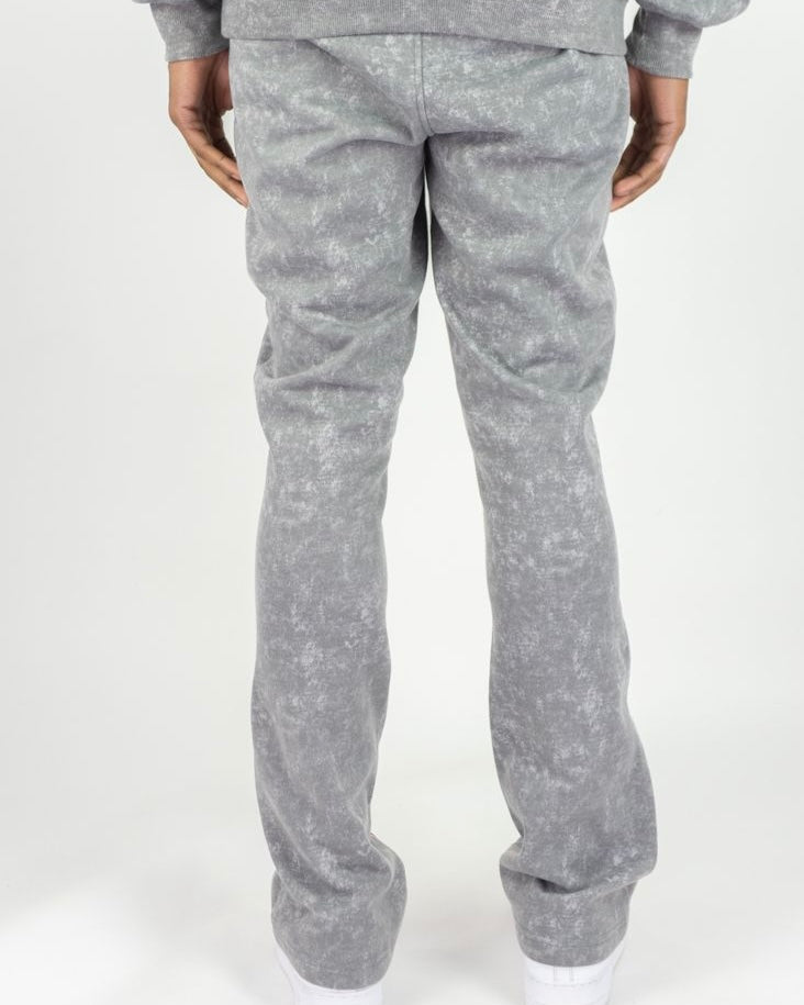 Gray sweatpants worn by a person on a white background