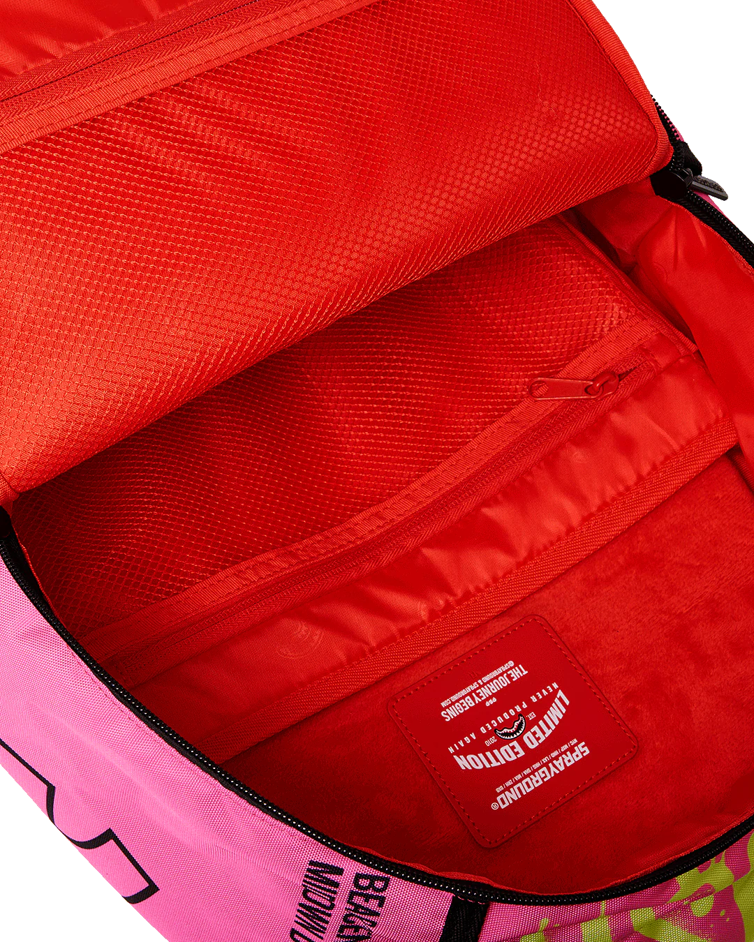 Close-up of a red interior of a pink bag with a visible brand label.