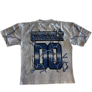 Gray t-shirt with 'GRIZZLY' and 'DO' printed on it against a white background