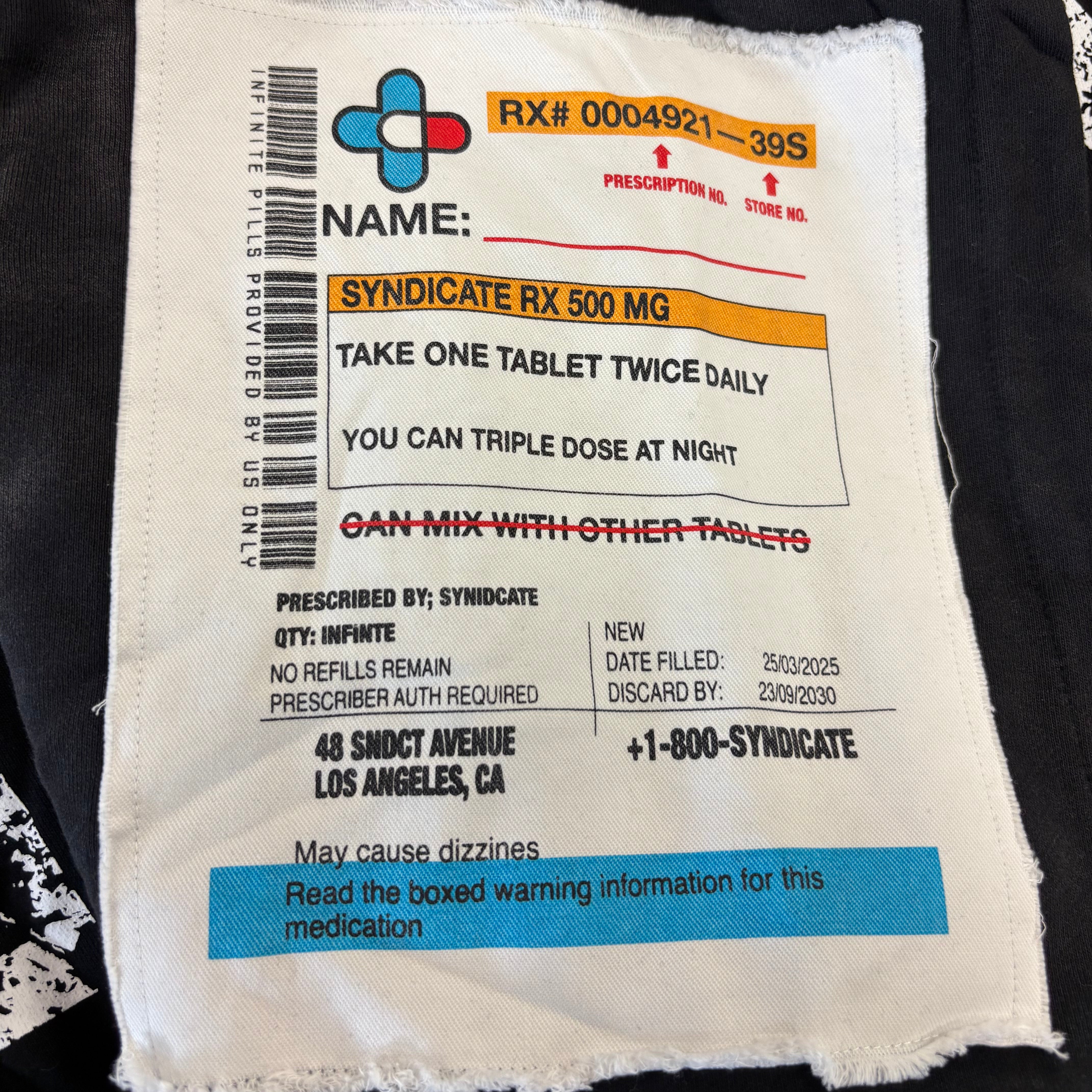 Prescription label on a piece of fabric with text and barcodes.