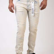 Beige distressed jeans with a visible brand tag on a white background