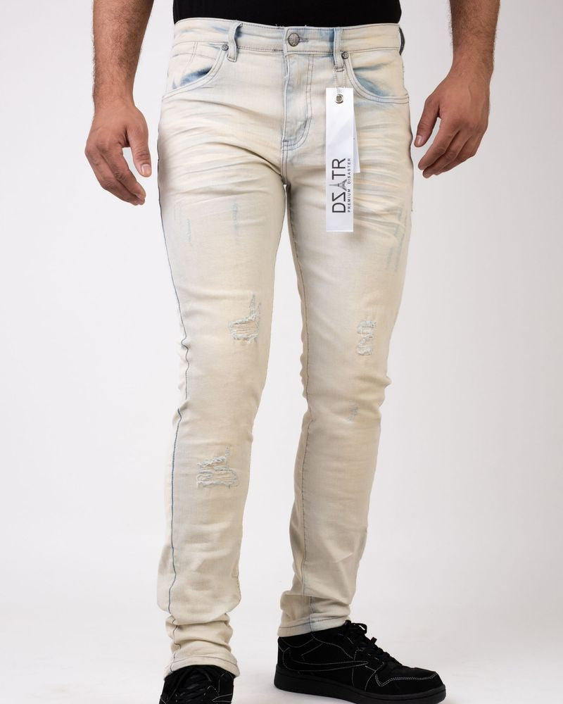 Beige distressed jeans with a visible brand tag on a white background