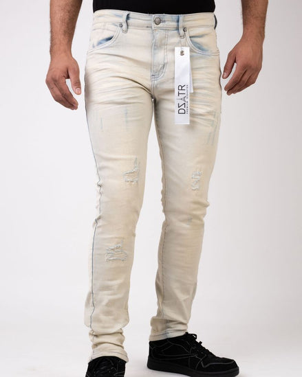 Beige distressed jeans with a visible brand tag on a white background