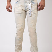White distressed jeans with a visible brand tag on a white background