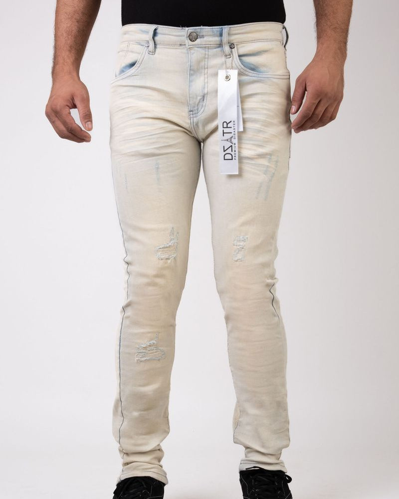White distressed jeans with a visible brand tag on a white background