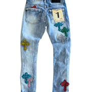 Light blue jeans with colorful cross patches on a white background