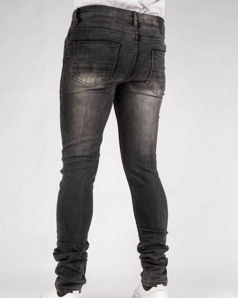 Person wearing black jeans on a white background