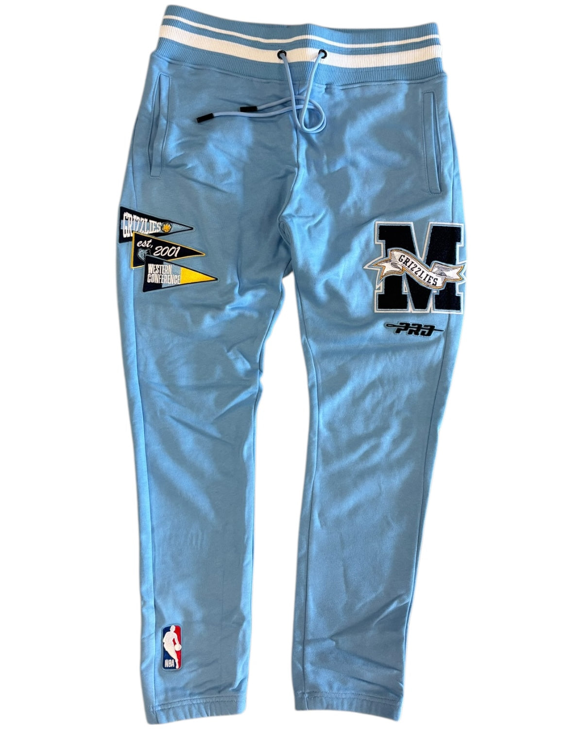Light blue sweatpants with patches and logos on a white background