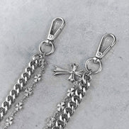 Silver chain with clasp and decorative elements on a gray background
