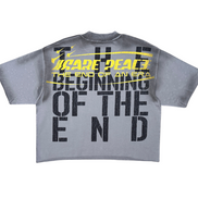 Gray t-shirt with black and yellow text on a white background