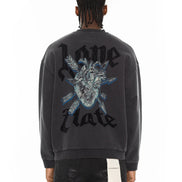 Person wearing a black sweatshirt with a graphic design and text on the back, on a white background