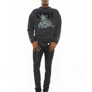 Man wearing a black sweatshirt with graphic design and text, standing against a white background